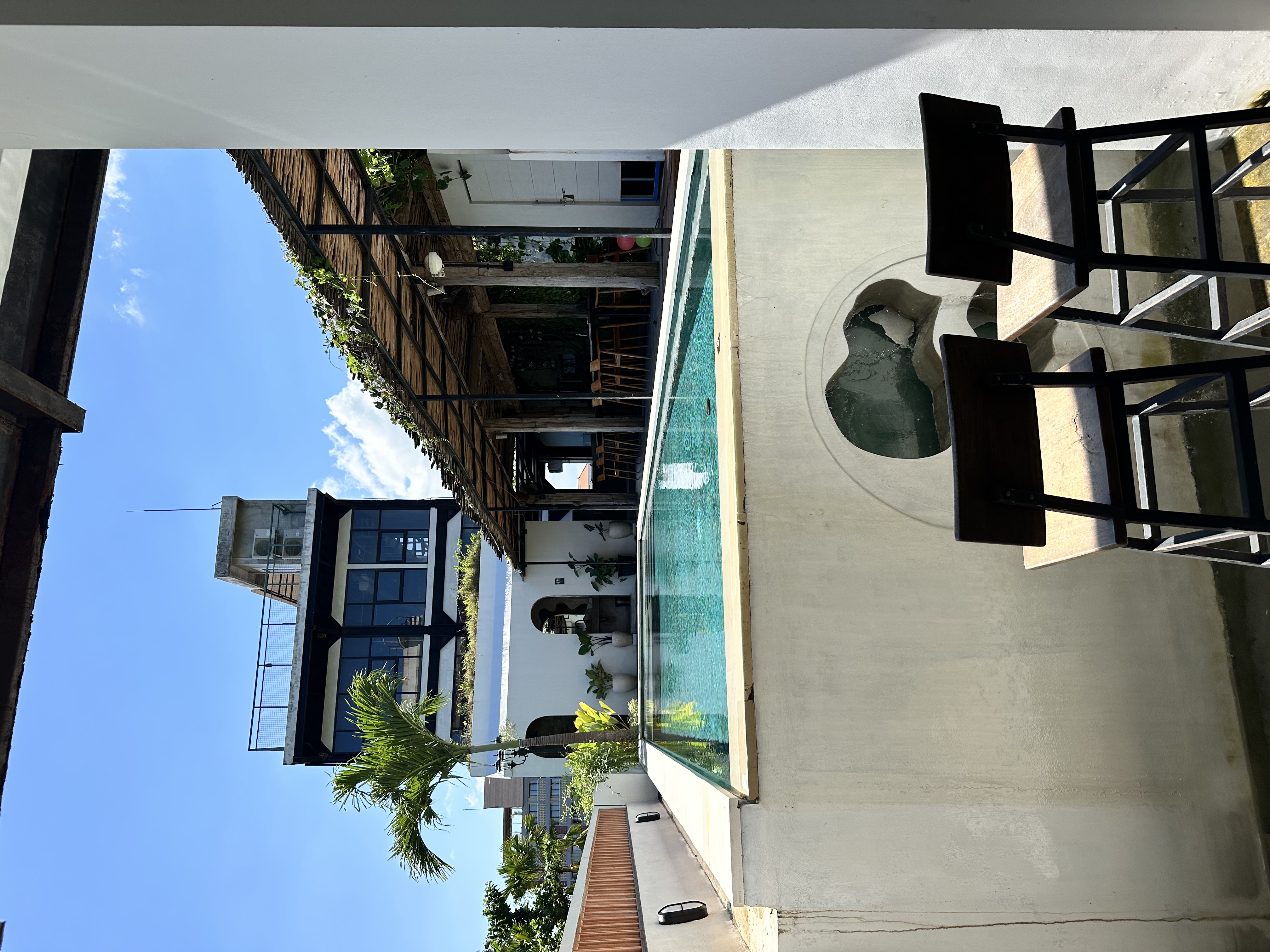 Open-air Canggu coworking terrace with laptops and tropical planting